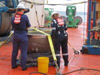 Los ingenieros de la Guardia Costera examinan la tapa de titanio de popa del submarino Titan